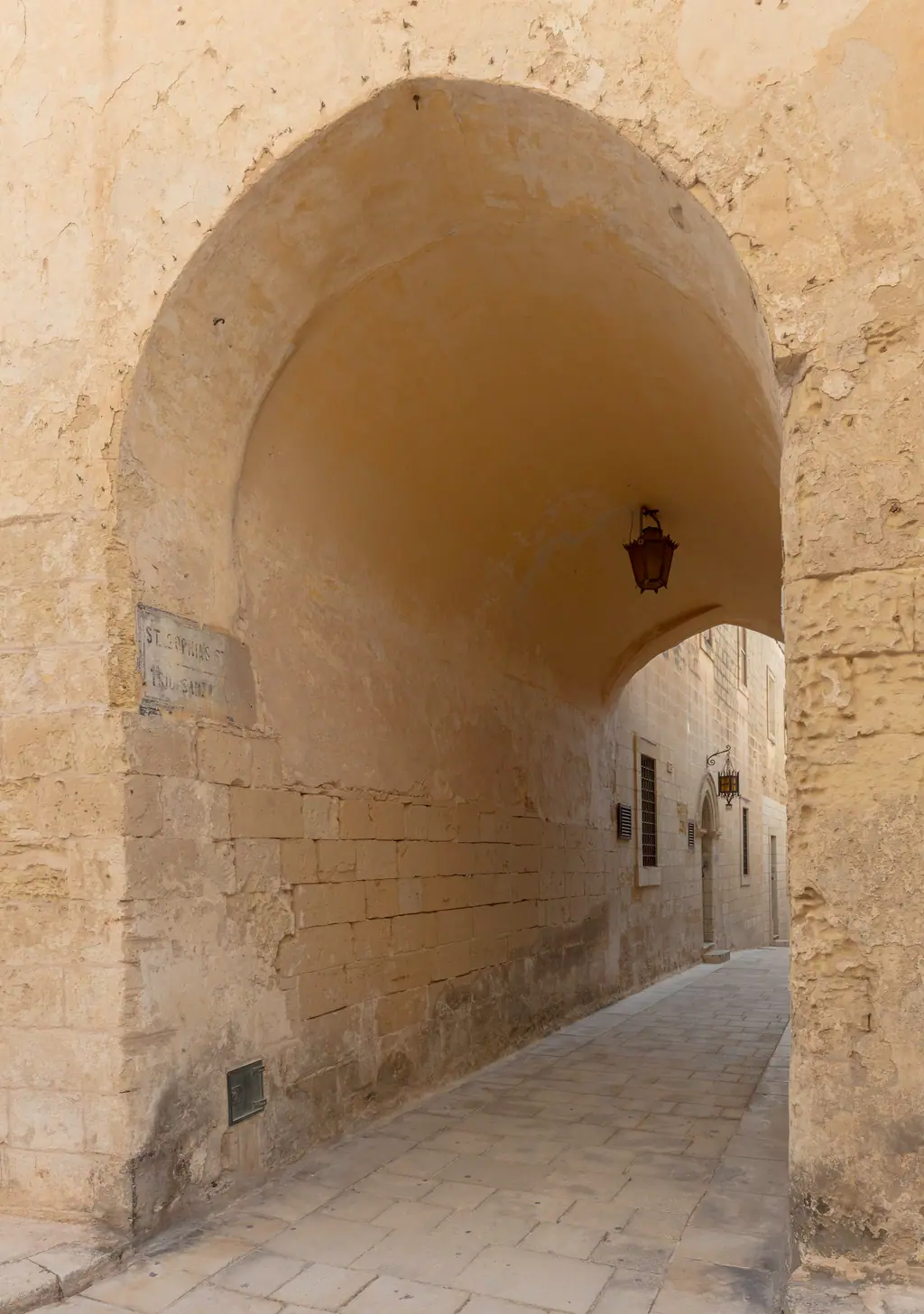 A narrow limestone archway in Mdina